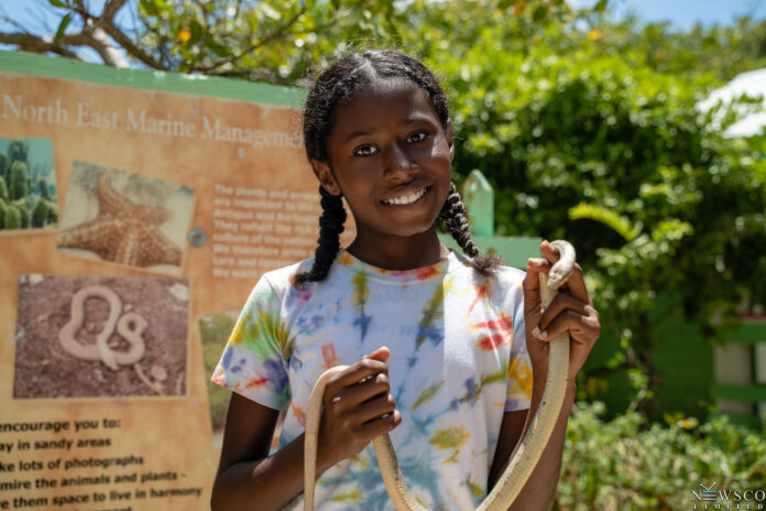 1 willikies primary student poses with the endemic antiguan racer and hopes to start her own conservation organization in the future. credits chaso media